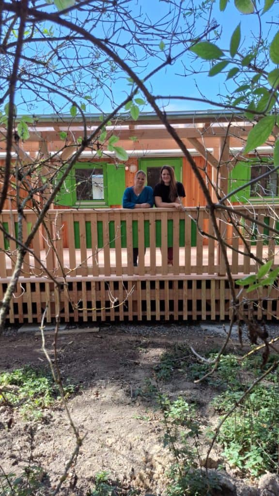 Das Team des Waldkindergarten steht auf der Terrasse des Bauwagen.